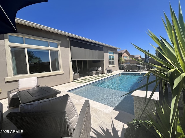 pool featuring a patio, outdoor dining area, and an outdoor living space