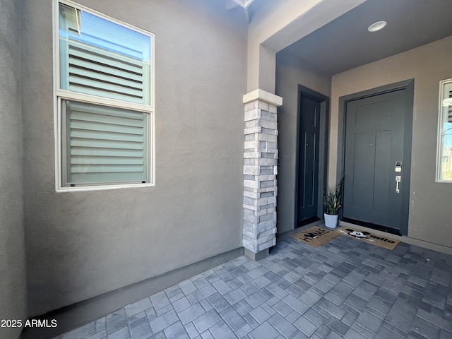 property entrance featuring stucco siding