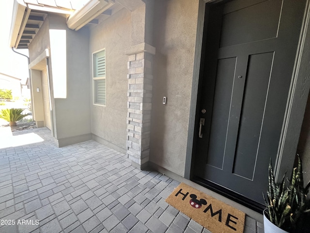 doorway to property with stucco siding