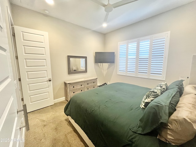 bedroom with baseboards, a ceiling fan, and light colored carpet