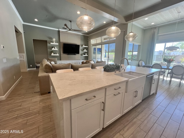 kitchen featuring crown molding, a sink, and wood tiled floor