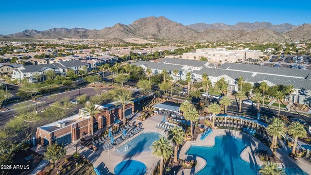 20546 W Summit Pl, Buckeye, AZ 85396 - aerial overview of property's location with nearby suburban area, a pool, and a mountain backdrop