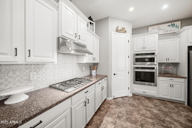 20546 W Summit Pl, Buckeye, AZ 85396 - kitchen featuring under cabinet range hood, stainless steel appliances, white cabinets, decorative backsplash, and recessed lighting