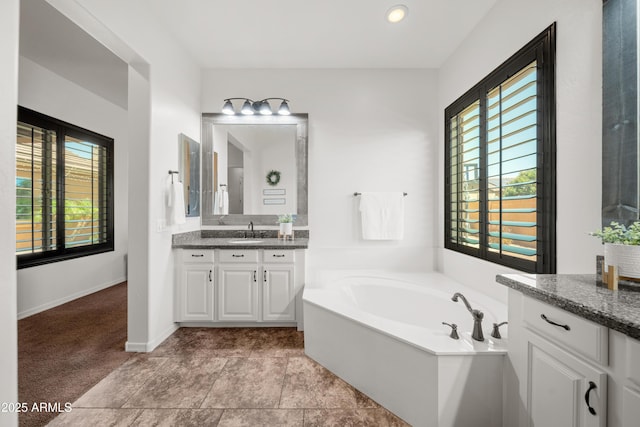 20546 W Summit Pl, Buckeye, AZ 85396 - full bathroom with plenty of natural light, a bath, vanity, baseboards, and recessed lighting