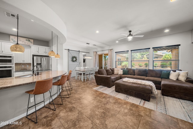 20546 W Summit Pl, Buckeye, AZ 85396 - living room featuring a ceiling fan and recessed lighting