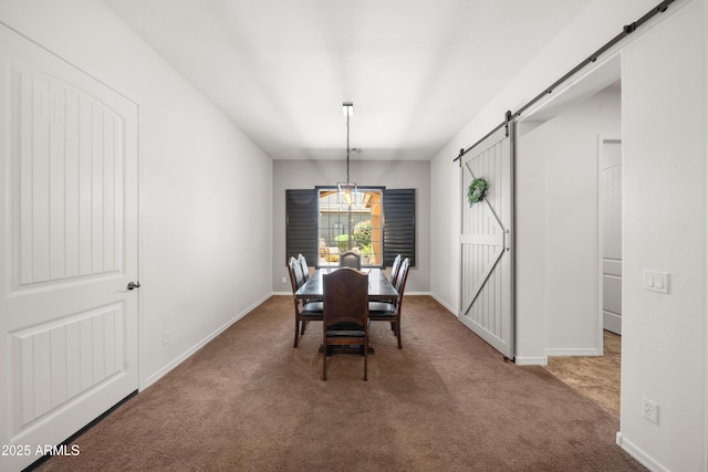20546 W Summit Pl, Buckeye, AZ 85396 - dining area featuring a barn door, carpet floors, and baseboards