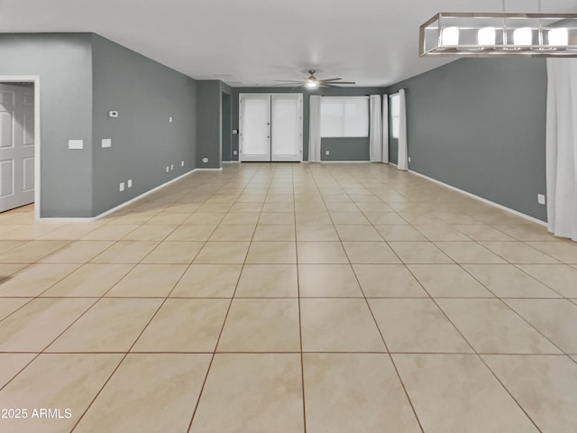 spare room with ceiling fan and light tile patterned floors