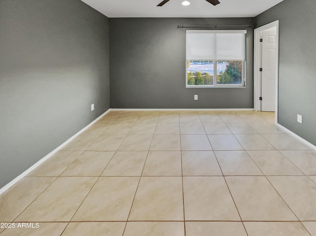 empty room featuring ceiling fan and light tile patterned floors