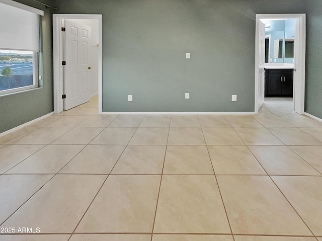 unfurnished room featuring light tile patterned floors