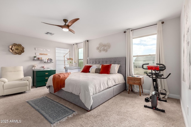 carpeted bedroom featuring multiple windows, ceiling fan, visible vents, and baseboards