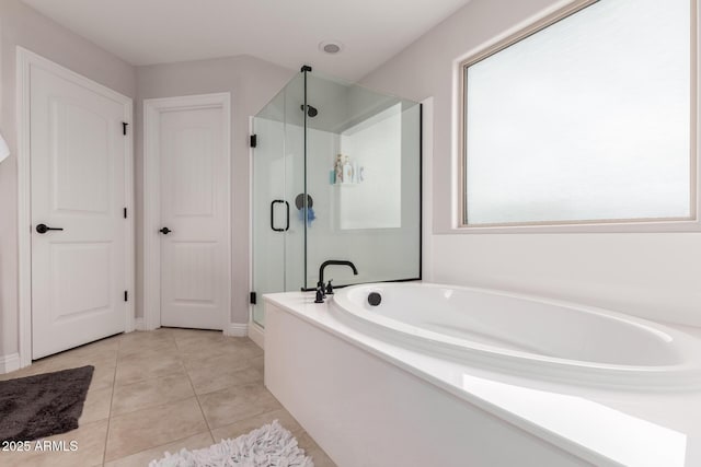 bathroom featuring a garden tub, tile patterned flooring, and a stall shower