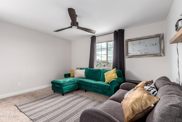 carpeted living room with ceiling fan and baseboards