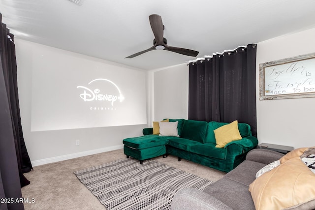 living area featuring a ceiling fan, baseboards, and carpet flooring