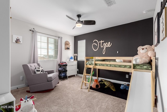 carpeted bedroom featuring baseboards, visible vents, and ceiling fan