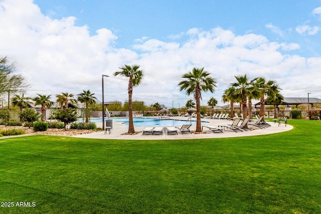 view of community with a pool, a patio area, and a yard