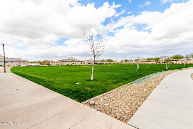 view of community with a yard and a residential view