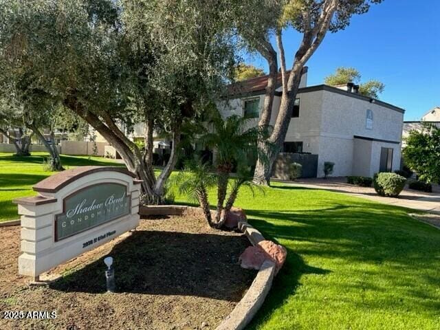 view of property's community with a lawn