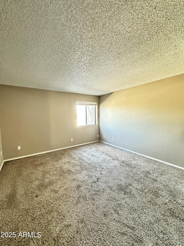 unfurnished room featuring carpet floors and a textured ceiling