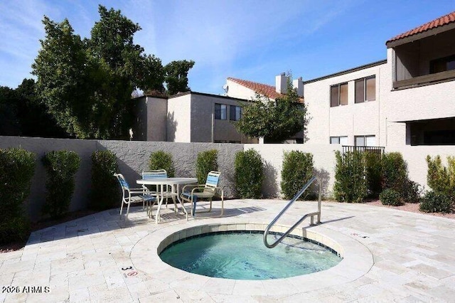 view of pool with a community hot tub and a patio area