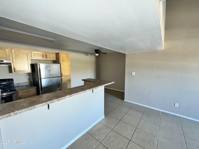 kitchen with stainless steel fridge, a kitchen breakfast bar, black electric range, light tile patterned flooring, and kitchen peninsula