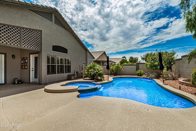 view of swimming pool with an in ground hot tub and a patio area