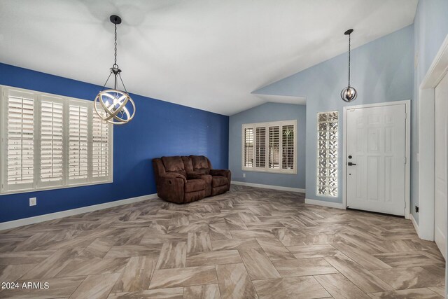 living room featuring parquet flooring, ceiling fan with notable chandelier, and lofted ceiling