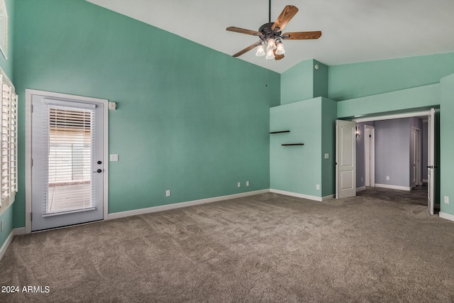 interior space with baseboards, ceiling fan, carpet, access to outside, and high vaulted ceiling