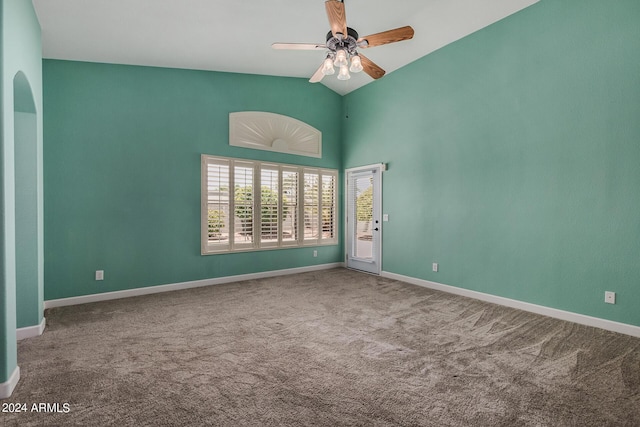 spare room featuring carpet floors, high vaulted ceiling, baseboards, and a ceiling fan