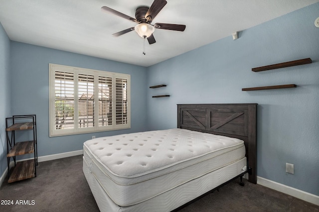 bedroom featuring dark carpet, baseboards, and ceiling fan