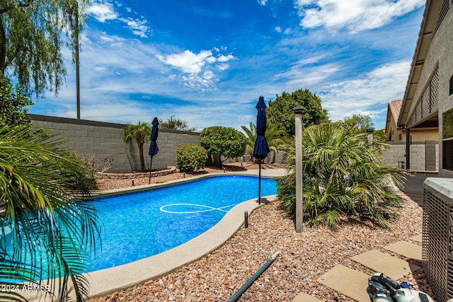 view of swimming pool featuring a fenced in pool, a fenced backyard, and central air condition unit