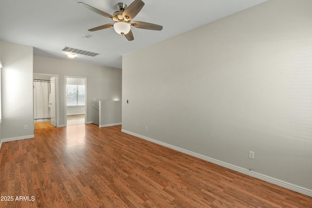 empty room featuring hardwood / wood-style flooring and ceiling fan