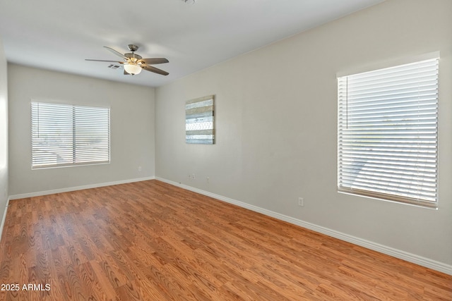 unfurnished room with hardwood / wood-style flooring and ceiling fan