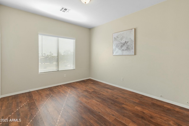 empty room featuring dark hardwood / wood-style flooring