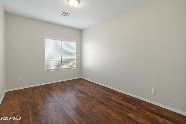 empty room featuring dark hardwood / wood-style flooring