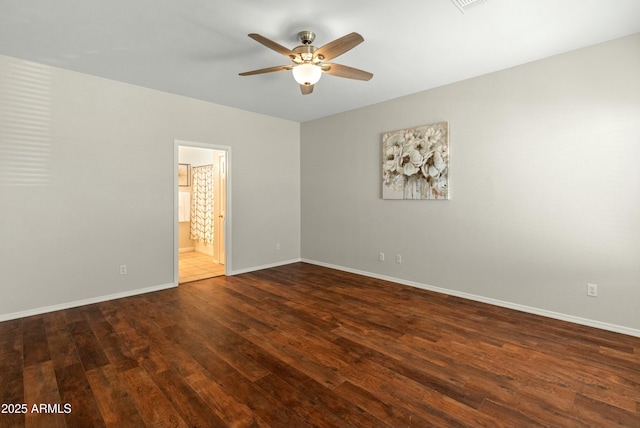 empty room with dark hardwood / wood-style floors and ceiling fan