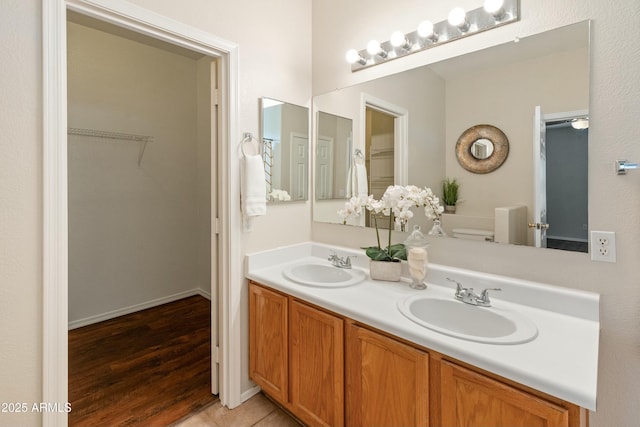 bathroom featuring hardwood / wood-style flooring, vanity, and toilet