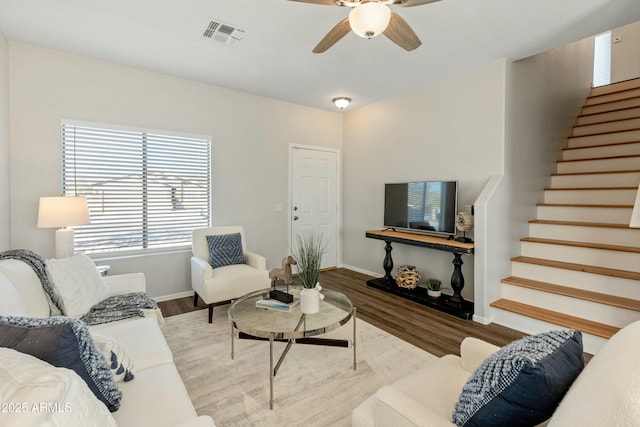 living room featuring light hardwood / wood-style floors and ceiling fan