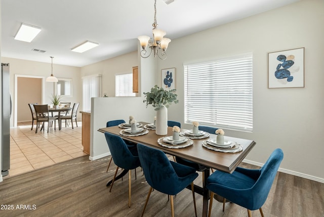 dining room featuring a notable chandelier and wood-type flooring