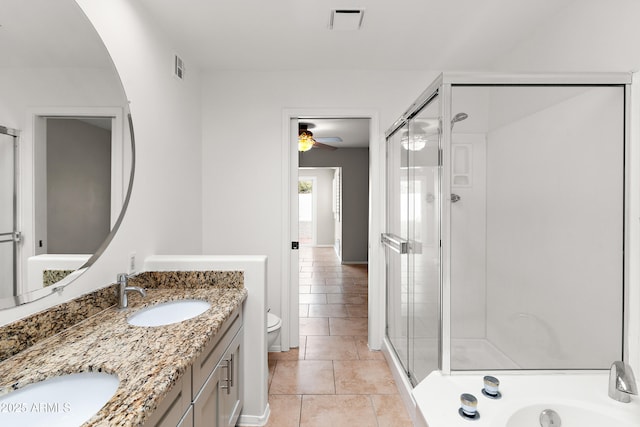 bathroom featuring double vanity, visible vents, toilet, a sink, and a shower stall