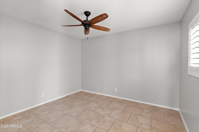 unfurnished room with ceiling fan, light tile patterned floors, and baseboards