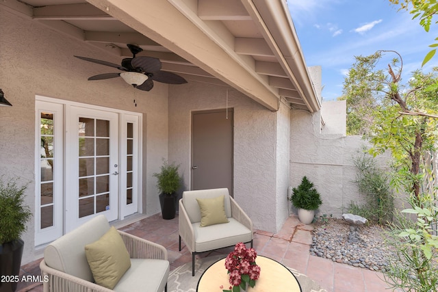 view of patio with french doors, fence, and a ceiling fan