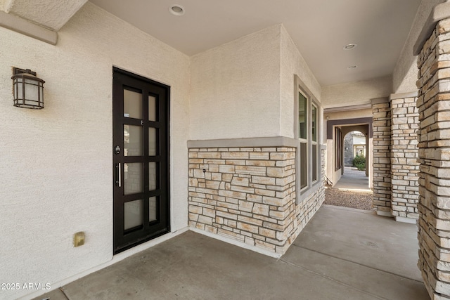 entrance to property featuring stucco siding