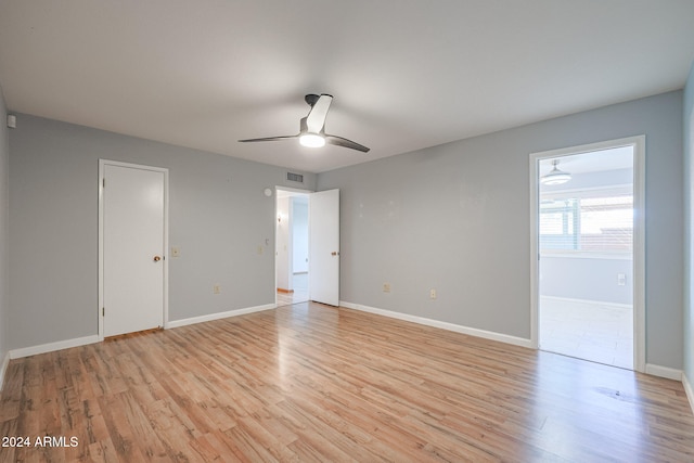 empty room with light hardwood / wood-style flooring and ceiling fan