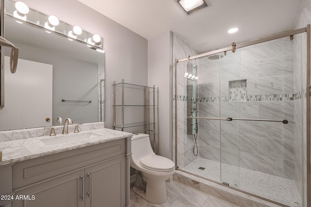 bathroom featuring toilet, an enclosed shower, and vanity