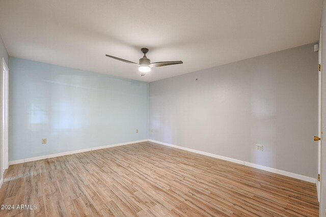 spare room with light hardwood / wood-style floors and ceiling fan