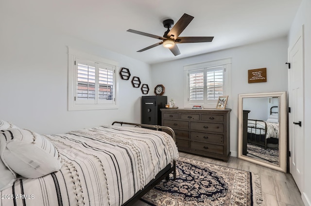 bedroom with ceiling fan and light wood-type flooring