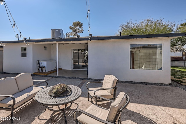 rear view of property with a patio, an outdoor hangout area, and central AC