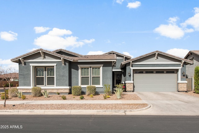 view of front of house with a garage, driveway, a tiled roof, and stucco siding