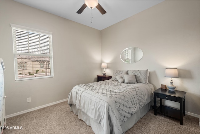 carpeted bedroom with ceiling fan and baseboards