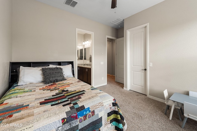 bedroom featuring baseboards, visible vents, light colored carpet, ceiling fan, and ensuite bathroom